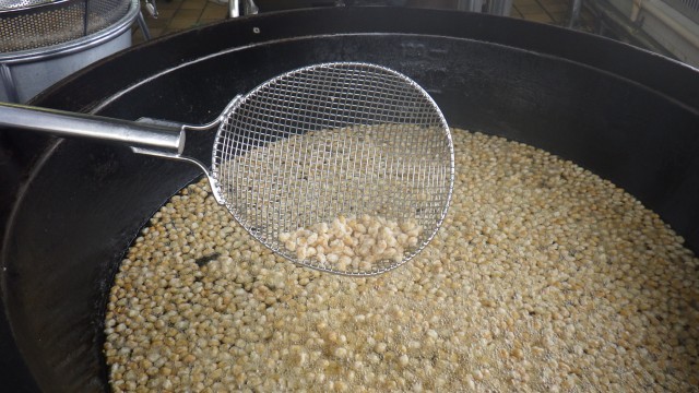 茹でて衣をつけた大豆を揚げているところです。